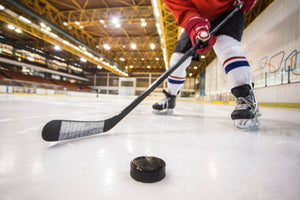 solo hockey player training hard on the ice with a puck